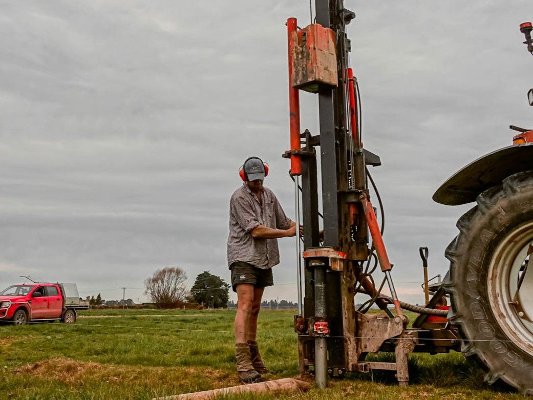 Otago fencing contractor using FencePro SM900 Sidemount Base with Mastshift, post driver extended out to fence line