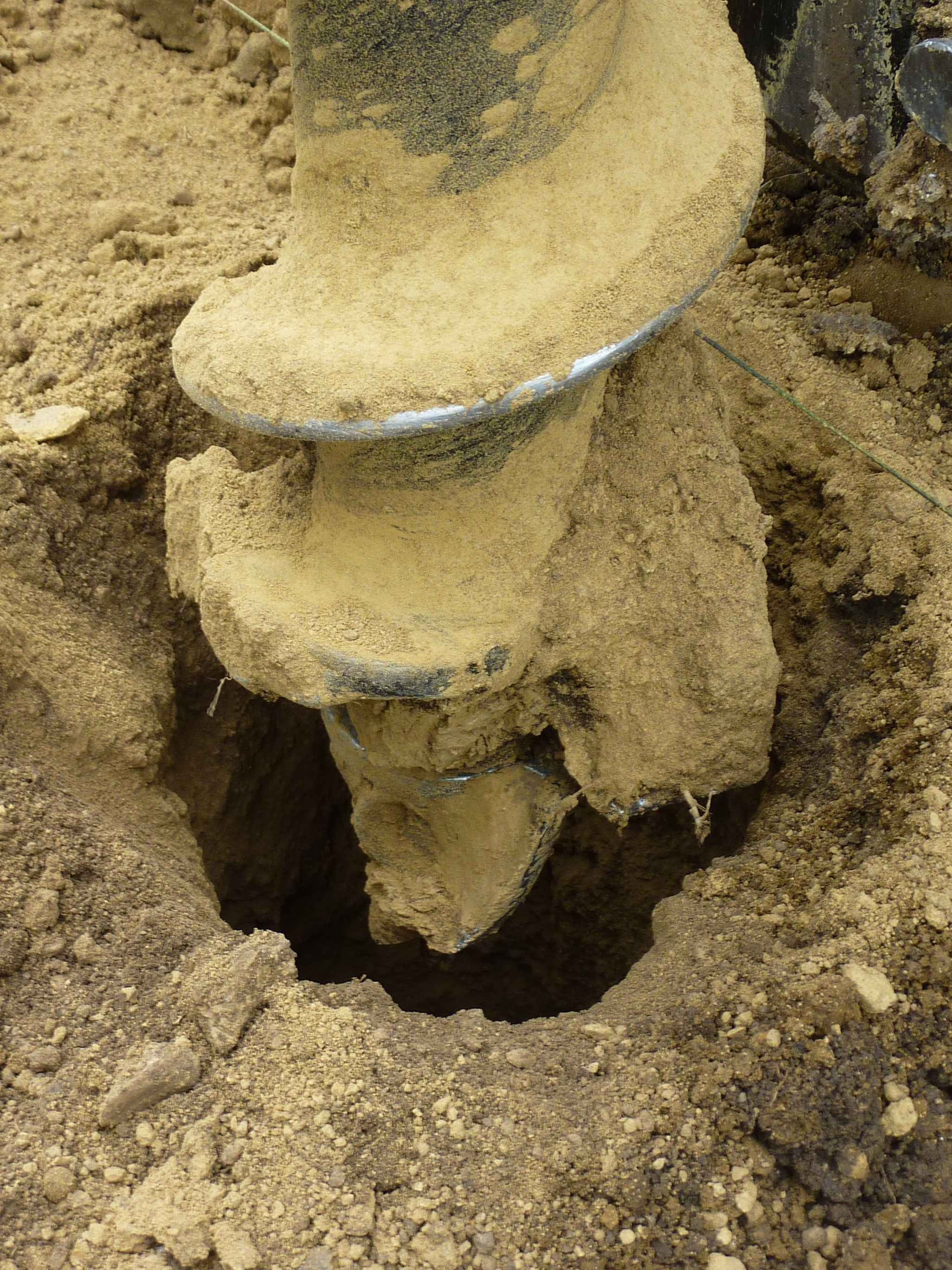 FencePro rock drill auger drilling a deep pilot hole for a post in hard ground