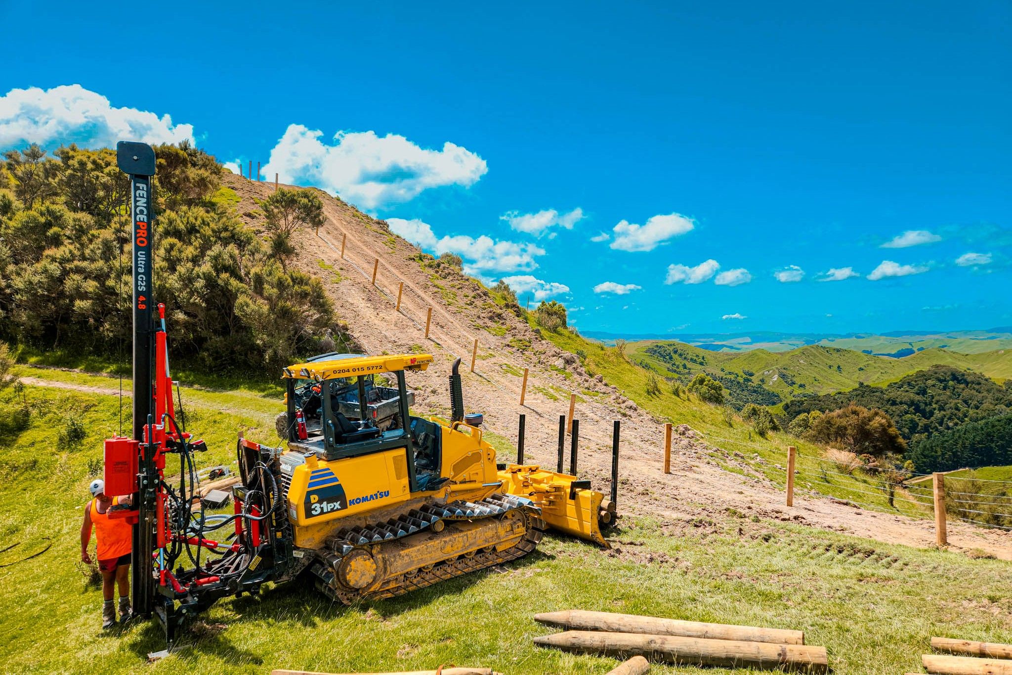 FencePro Ultra G2S post driver mounted on bulldozer installing fence posts on steep hill country fencing project