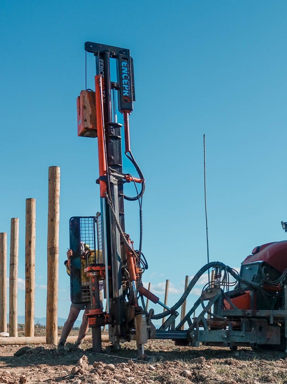 Far-side hydraulically positioned FencePro UltraGlide rockspike kit on Ultra T2, working in an orchard