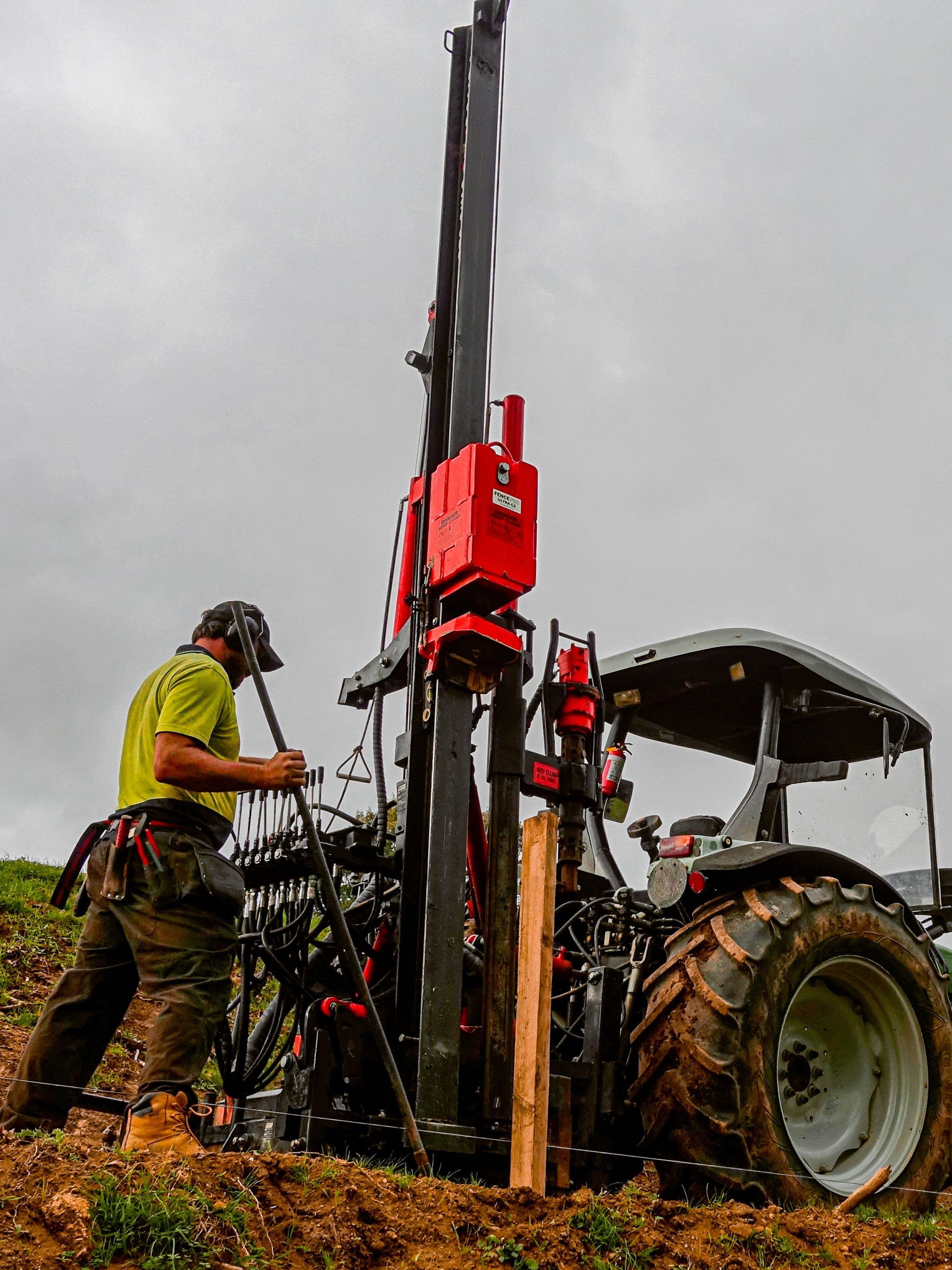 FencePro hydraulic post rammer with rock drill attachment being set up for drilling.