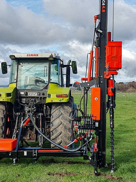 FencePro tractor mounted post driver fitted with rock drill attachment ready for drilling pilot holes in tough ground