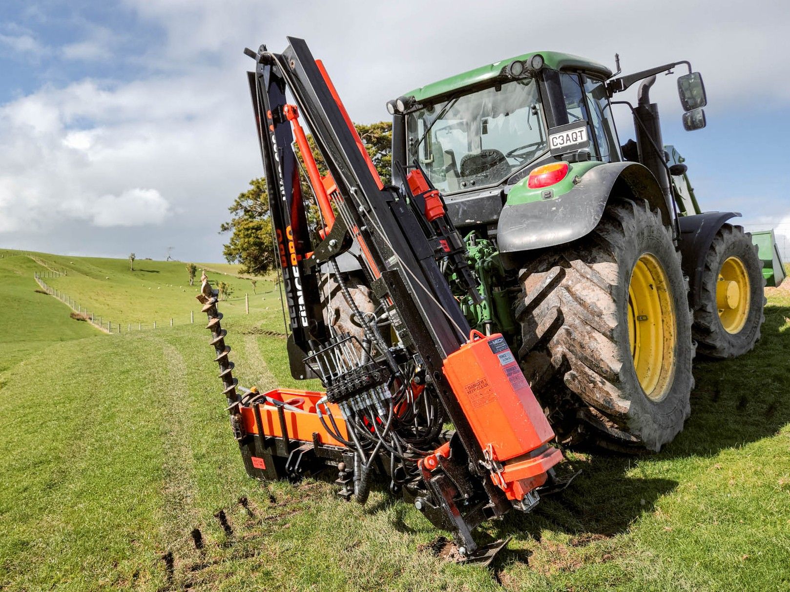 Complete FencePro setup showing post driver, SM900 Sidemount Base, and rockdrill stored on base, with toolbox also in use.