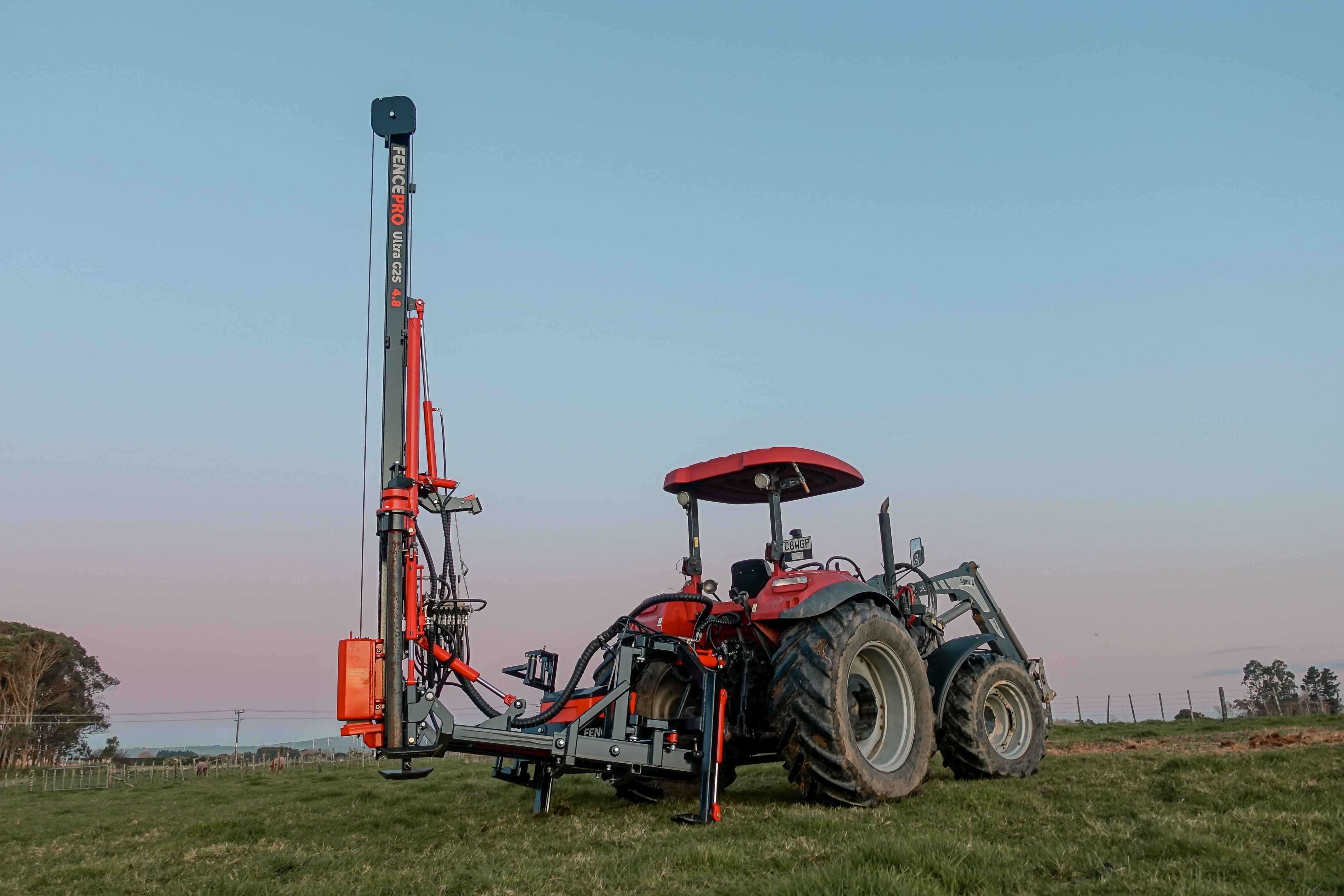 FencePro Ultra G2S post driver with Rockspike and PB650 rotating base mounted on tractor, ready for fence post installation