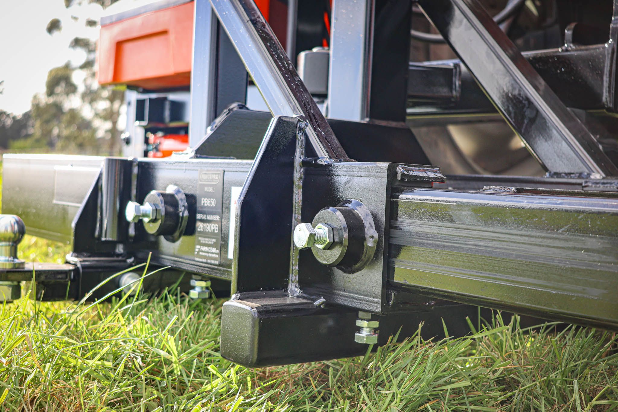 Close-up of the FencePro PB650 post driver base showing the adjustable, replaceable plastic slides and strengthening gussets.