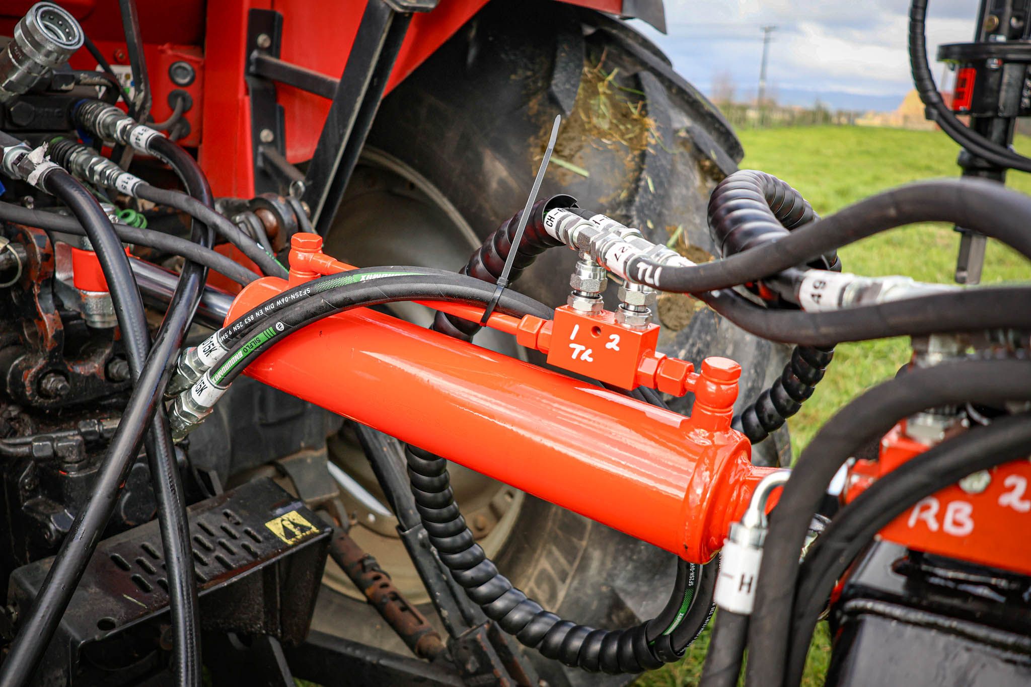 Close-up of the FencePro PB650 post driver base showing the hydraulic toplink connecting to the tractor.
