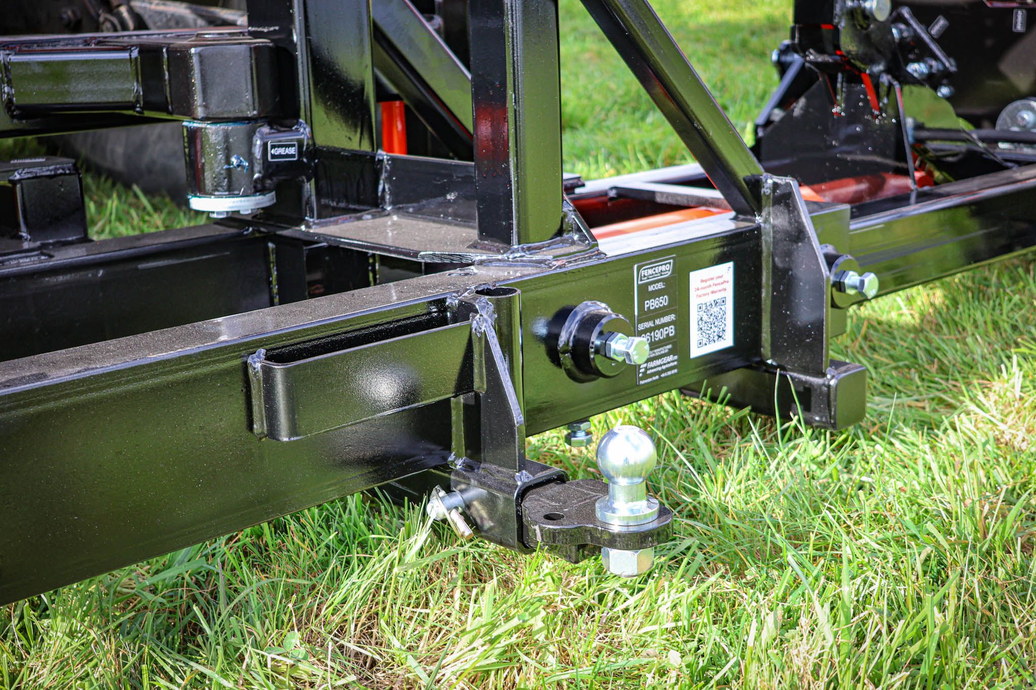 FencePro PB650 post driver base showing the spade holder, hand rammer holder, and towbar.