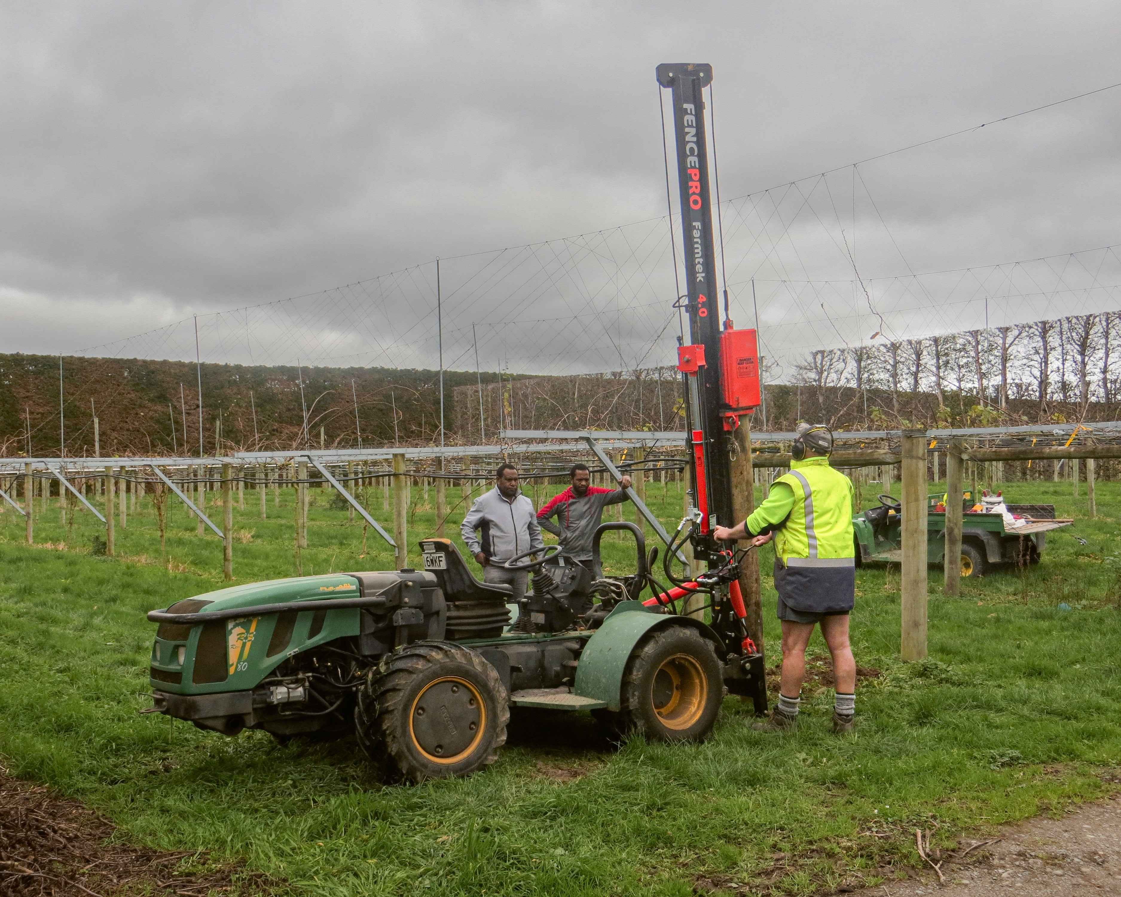 FencePro Farmtek post driver operating in an orchard, ideal for vineyard and horticultural fencing